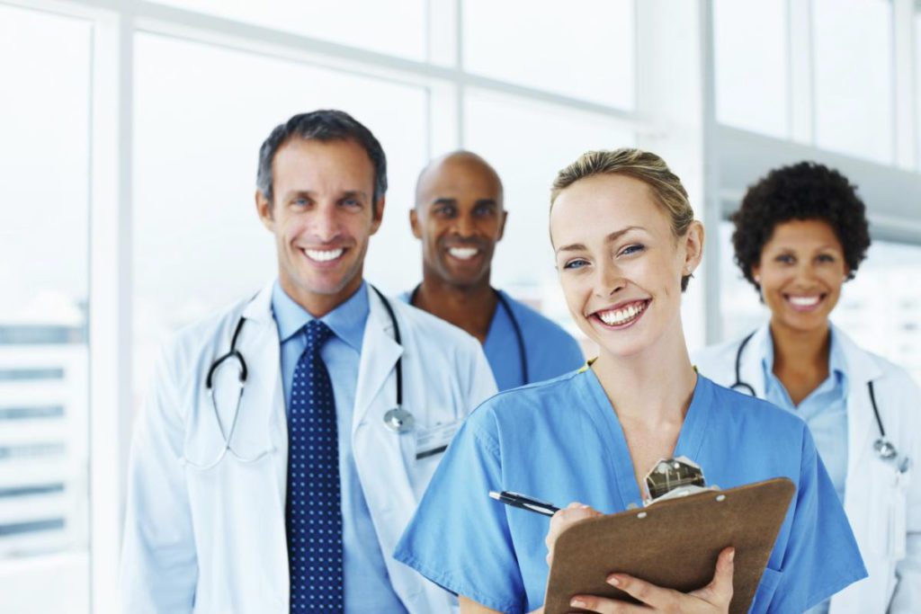 A group of doctors and nurses standing in front of each other.